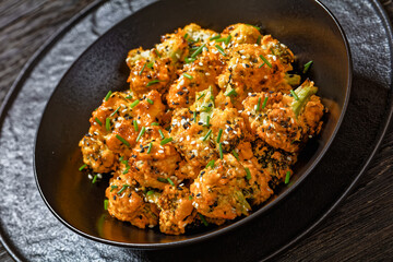 bang bang broccoli bites in bowl, top view