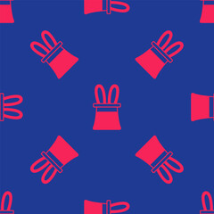 Fototapeta premium Red Magician hat and rabbit ears icon isolated seamless pattern on blue background. Magic trick. Mystery entertainment concept. Vector