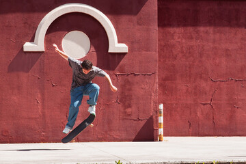 young skater boy jumping on the street