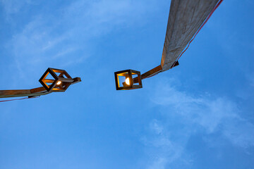 Wooden street lamp on blue sky