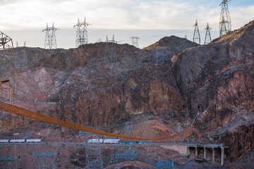 Dawning Legacy: 4K Video of Hoover Dam with Original Crane Illuminated by Sunrise