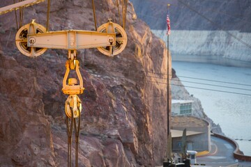 Dawning Legacy: 4K Video of Hoover Dam with Original Crane Illuminated by Sunrise