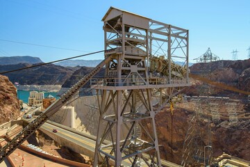 Dawning Legacy: 4K Video of Hoover Dam with Original Crane Illuminated by Sunrise