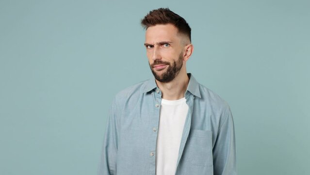 Young man wear shirt white t-shirt look camera pointing fingers himself ask say who me no thanks i do not need it isolated on plain pastel light blue cyan background studio. People lifestyle concept