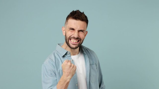 Fun happy young man wear shirt white t-shirt countdown 1 2 3 one two three go celebrate win scream rejoices do winner hands gesture say yes isolated on plain pastel light blue cyan background studio