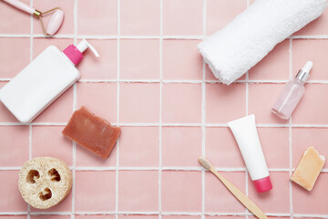 Cosmetic beauty products on pink background. Bottles and tubes with branding mock up. Skin care and beauty concept. Top view, flat lay, copy space