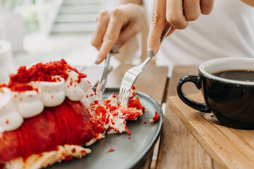 Cake being eat by asian woman in the cafe. Focus selective on the cake.