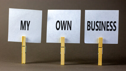 My own business symbol. Concept words My own business on beautiful white paper on clothespin. Beautiful grey background. Business motivational my own business concept. Copy space.