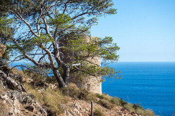 Fototapeta na wymiar Mediterranean coastal landscape. Historic Torre Vigia De Cerro Gordo, a watchtower looking out for any marauding pirates. La Herradura, Andulasia, Southern Spain