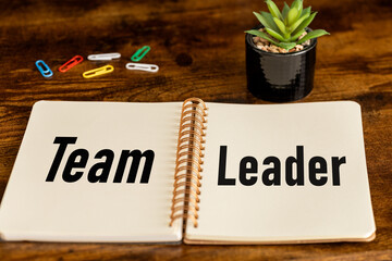 the word team leader written in a business notebook on the boss's desk, Business concept, close up