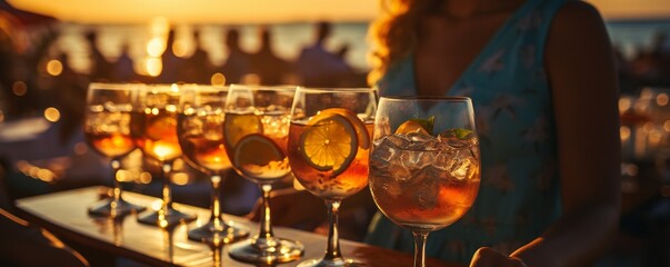 serving champagne off a tray by a waiter. vacation to a summer beach for the sunset. - obrazy, fototapety, plakaty