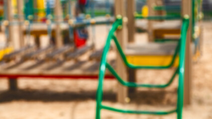 Abstract blur Children playground. Empty colorful children playground set in park. Outdoor playground. Sandy ground