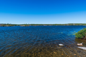 Beautiful blue lake sparkles in sunlight near Yellowknife, Northwest Territories, Canada