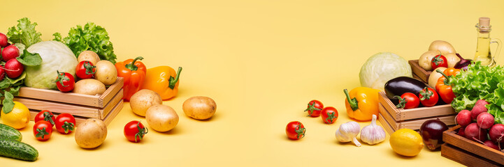 Different types of fresh vegetables on a yellow background. Cabbage, potatoes, cucumbers, peppers, garlic, tomatoes, eggplant, lettuce. Vegetable oil. Harvest.