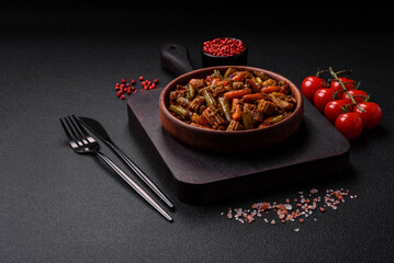 Mix of vegetables corn, carrots, peppers, broccoli, onions in teriyaki sauce on a ceramic plate