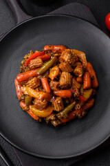 Mix of vegetables corn, carrots, peppers, broccoli, onions in teriyaki sauce on a ceramic plate