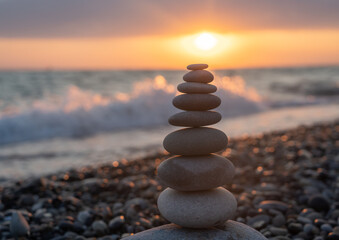 Pyramid of stones for meditation lying on sea coast at sunset - 638059518