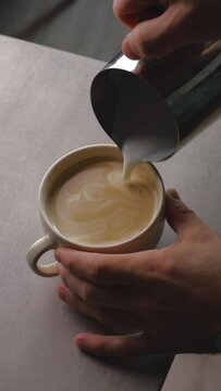 Barista making of cafe latte art, heart shape. Making Cappuchino in Coffeeshop
