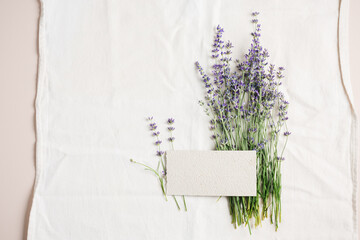 Blank card mockup, lavender on linen tablecloth.