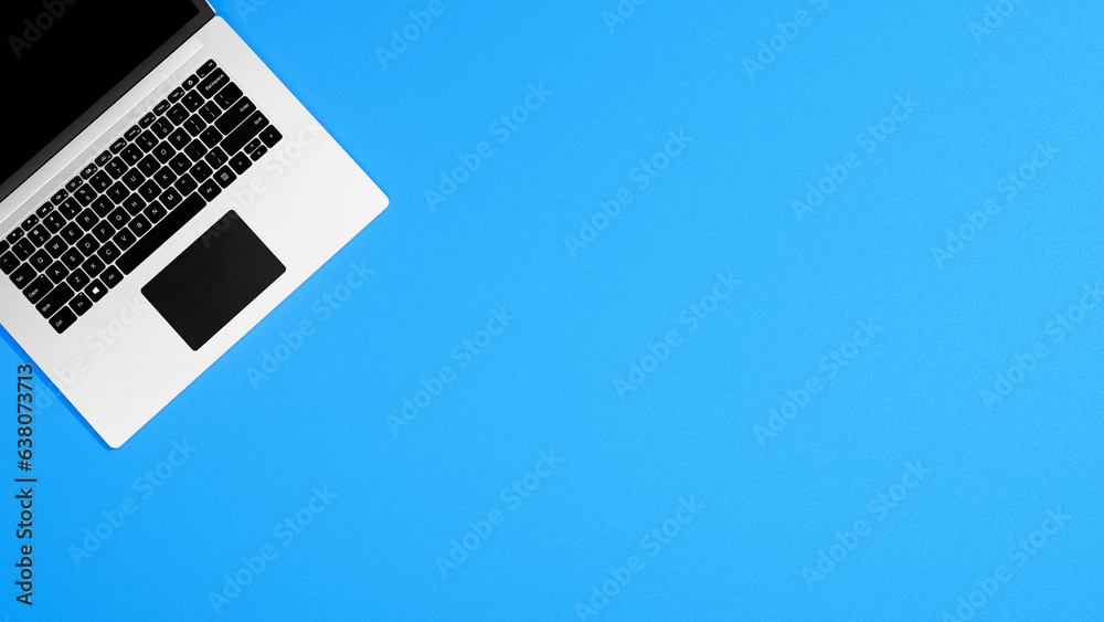 Poster Top view laptop mock up on empty blue table background, empty place, table - can be used for text or design