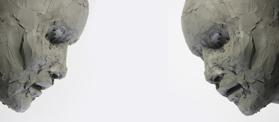 Pair of clay faces on a white background. Portrait, sketch without eyes. Artwork in process of...