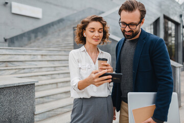 man and woman business partners working together