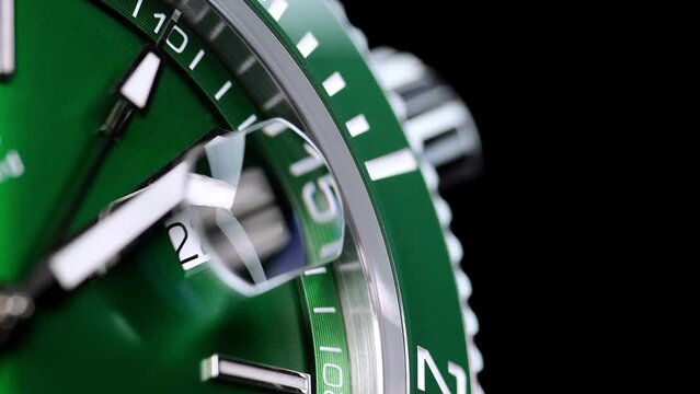 Stylish Luxury Man Wrist Watch With Moving Hand And Multiple Dials. Men's watch in metal with sapphire crystal. Closeup view of rotating watch, running second arrow. green dial. Cyclops watch