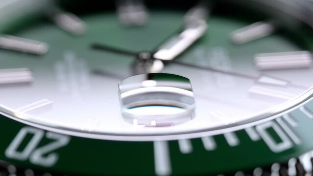 Stylish Luxury Man Wrist Watch With Moving Hand And Multiple Dials. Men's watch in metal with sapphire crystal. Closeup view of rotating watch, running second arrow. green dial. Cyclops watch