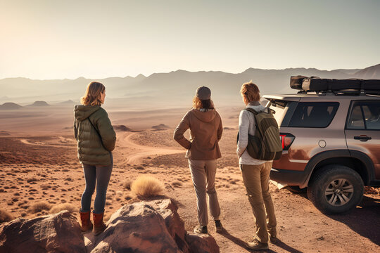 Friends On A Road Trip Stopping To Take Photos At A Desert Viewpoint.