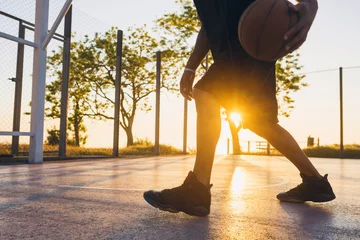  black man doing sports, playing basketball on sunrise, active lifestyle, sunny summer morning © mary_markevich