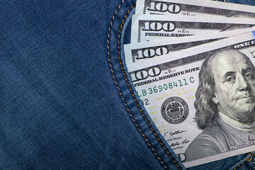 money in your pocket. dollar bills in jeans pocket. The concept of pocket money. Cash. American...