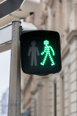 Green pedestrian light with a universal walking person
