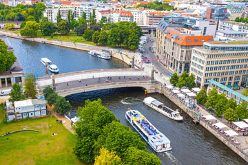 Fototapety  Skyline aerial view of Spree River and Museum island (Museumsinsel) in Berlin, Germany. Friedrichsbrucke bridge and Berlin touristic tour boats on the river