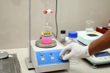 Laboratory personnel tested FFA levels in cooking oil using a magnetic stirrer. analysis of the FFA...