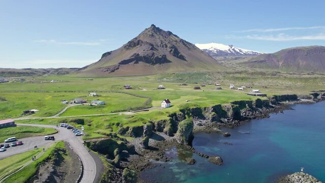 Arnastapi fishing village with white house and mount Stapafell on coastline in Snaefellsnes peninsula