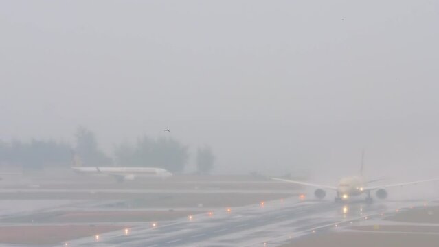 Wide body airliner take off in rain at Phuket airport. Flight departure. Aircraft accelerating on a wet runway. Tourism and travel concept