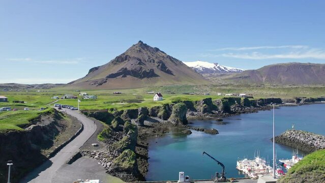 Arnastapi fishing village with white house and mount Stapafell on coastline in Snaefellsnes peninsula
