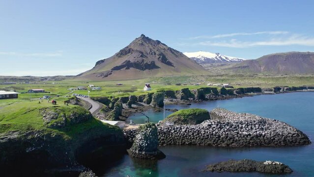 Arnastapi fishing village with white house and mount Stapafell on coastline in Snaefellsnes peninsula