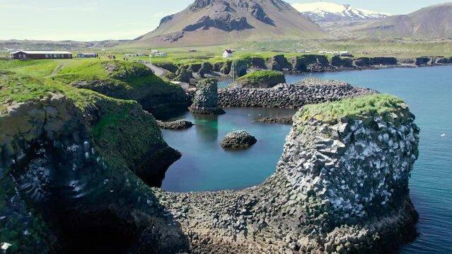 Arnastapi fishing village with white house and mount Stapafell on coastline in Snaefellsnes peninsula
