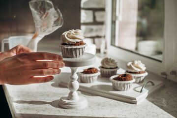 Chocolate muffins. Homemade chocolate muffins. The process of making homemade chocolate cupcakes with whipped cream.