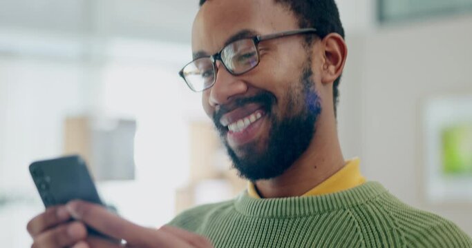 Phone, happy and social media with a black man laughing at a meme while in his office at work for business. Face, communication and smile with a young employee looking at a text message on his mobile