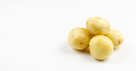 Four young potatoes are isolated on a white background. Fresh homegrown vegetables, young potatoes.