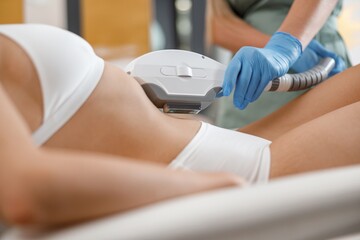 Closeup of young woman getting laser epilation with ipl machine in beauty center. Hair removal
