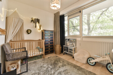 a baby's room with a cribt in the corner and toys on the floor next to the cribt