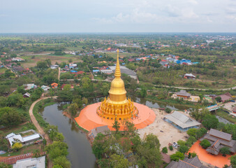 Naklejka premium Aerial top view of The Isan pagoda is a buddhist temple near Bangkok, an urban city town, Thailand. Thai architecture landscape background. Tourist attraction landmark.