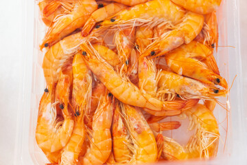 Shrimp on ice in a store fridge, background