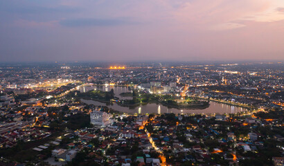 Fototapeta premium Aerial view of Udon Thani, residential neighborhood roofs. Urban housing development from above. Top view. Real estate in Kalasin, Isan province city, Thailand. Property real estate.