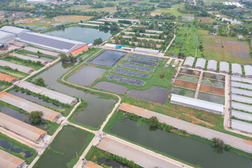 Aerial view of stack of different types of large garbage pile, plastic bags, and trash with a tractor car in industrial factory in environmental pollution. Waste disposal in dumping site.