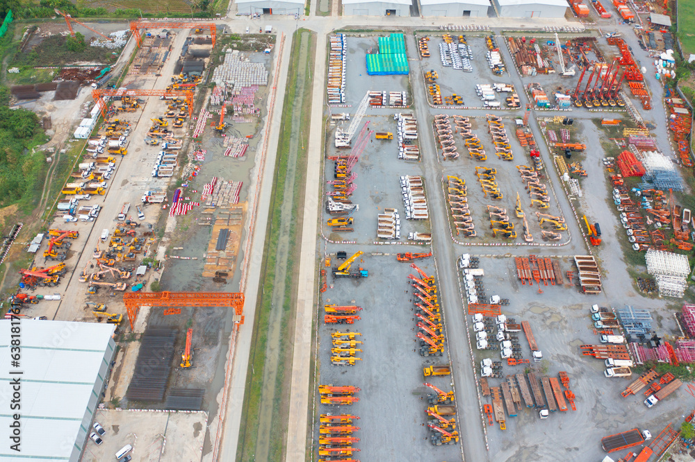 Wall mural Aerial view of tractor truck cars in industrial factory for construction site.