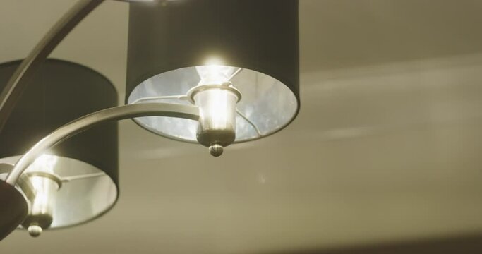 lights on chandelier shaking and flickering closeup 